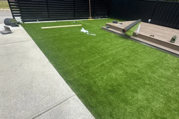 Artificial turf and composite deck steps during a backyard landscaping project in Port Coquitlam